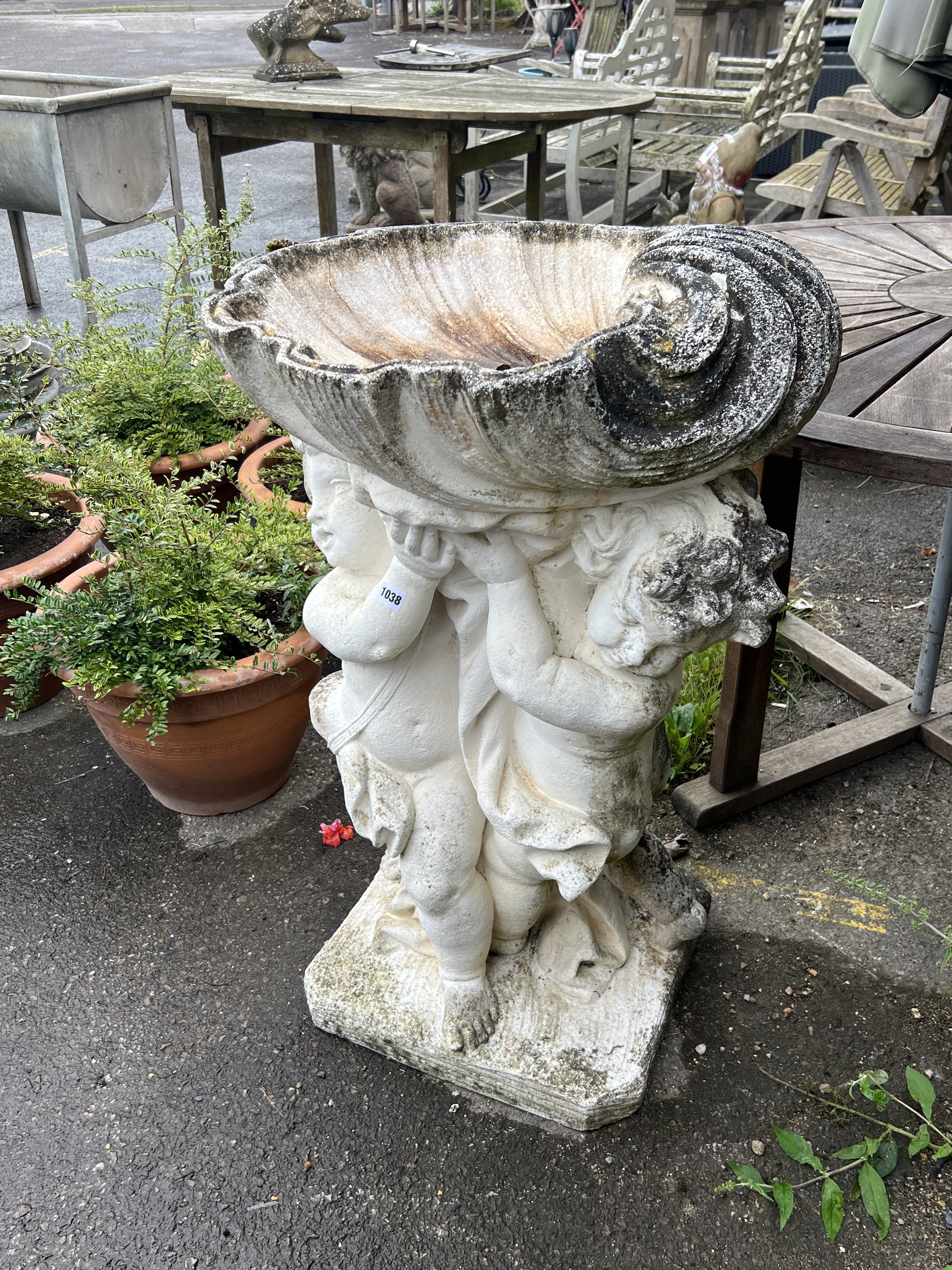 A large painted stone cherub and scallop shell garden fountain, height 93cm